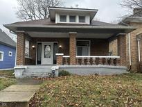 Charming brick home with a cozy front porch, perfect for relaxing outdoors at 4130 Rookwood Ave, Indianapolis, IN 46208