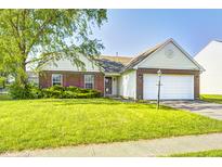 Charming one-story home with manicured lawn and two-car garage on a sunny day at 431 Alton Dr, Greenwood, IN 46143