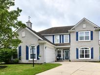 Charming two-story home features a brick facade, blue shutters, well-manicured lawn, and attached garage at 6126 Navy Cir, Indianapolis, IN 46221
