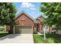 Beautiful brick home with a well-maintained lawn, a two-car garage, and lovely landscaping at 6570 Freemont Ln, Carmel, IN 46033