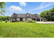 Charming home boasts dormer windows, a two-car garage, and lush landscaping at 750 N 500 W, Lebanon, IN 46052