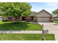 Charming single-Gathering home with brick facade, lush green lawn, mature tree, and attached garage at 767 Harvest Ridge Dr, Avon, IN 46123