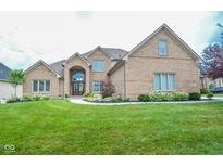Charming brick home with manicured lawn, lovely landscaping, and a welcoming entrance at 7845 Centerstone Ct, Indianapolis, IN 46259