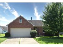 Charming one-story brick home featuring an attached garage and well-maintained landscaping at 7846 Park North Cir, Indianapolis, IN 46260