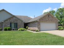 Charming single-story home featuring a brick facade, well-manicured lawn, and an attached two-car garage at 126 Old Farm Rd, Danville, IN 46122