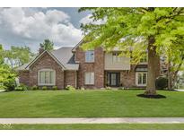 Charming brick two-story home featuring lush front lawn and mature trees in a desirable location at 1393 Stoney Creek Cir, Carmel, IN 46032