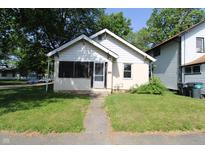 Charming single-story home featuring a screened-in porch and a well-maintained front yard at 2025 Fairview St, Anderson, IN 46016