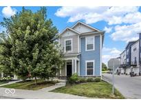 Charming two-story home featuring two-tone siding, front porch, landscaped yard and stone accents at 214 Handley St, Indianapolis, IN 46222