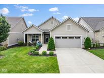 Charming home showcasing a manicured lawn and inviting front porch with stone accents and two-car garage at 2246 Heather Glen Way, Franklin, IN 46131