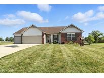 Charming single-story home featuring a manicured lawn, well-kept landscaping, and a two-car garage, perfect for curb appeal at 2308 E Mill Stream Dr, Greenfield, IN 46140