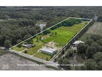 Beautiful aerial view of the property with a pond, pasture, trees, and outbuildings at 2868 S 525 W, Trafalgar, IN 46181