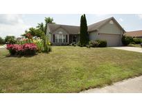 Charming single-Gathering home features a well-manicured lawn and colorful flower beds at 291 Lakemoore St, Brownsburg, IN 46112