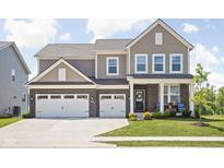 Charming two-story home with brick accents, a well-manicured lawn, and a spacious two-car garage at 3969 Canning St, Danville, IN 46122