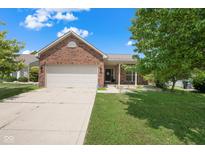 Charming brick home featuring an attached two-car garage and a well-maintained front lawn at 452 Southern Pines Dr, Whiteland, IN 46184