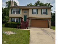 Charming two-story home featuring green shutters, a well-maintained lawn, and an attached two-car garage at 6611 Wandering Way, Indianapolis, IN 46241