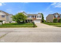 Charming two-story home with a well-manicured lawn, attached garage, and inviting front porch at 6848 Harriet Dr, Indianapolis, IN 46237