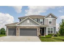 Charming two-story home featuring a two-car garage, manicured lawn, and classic architectural details at 6902 Diamondleaf Way, Brownsburg, IN 46112