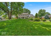 Inviting two-story home boasts lush front lawn and meticulously maintained landscaping, offering great curb appeal at 7502 Colony Cir, Indianapolis, IN 46260