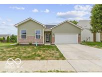 Charming home featuring a two car garage and well-maintained lawn at 8355 Fieldfare Way, Indianapolis, IN 46237