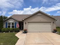 Charming single-story home featuring a beige exterior, manicured lawn, and an attached two-car garage at 9022 Hosta Way, Camby, IN 46113