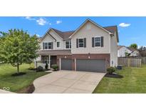 Charming two-story home with two-car garage, brick accents, and landscaped front yard at 9724 Brooks Dr, Fishers, IN 46055