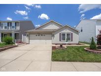 Charming single-Gathering home with a well-manicured lawn and attached two-car garage at 10758 Cyrus Dr, Indianapolis, IN 46231