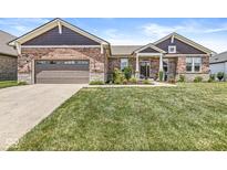 Charming brick home with well-manicured lawn and lovely front garden at 1165 Maclaren Ct, Franklin, IN 46131
