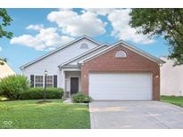 Charming single-story home with a well-manicured lawn, brick accents, and a two-car garage at 12604 Buck Run Dr, Noblesville, IN 46060