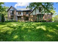 Charming two-story home with brick exterior, bay window, and lush green lawn at 160 Scranton Ct, Zionsville, IN 46077