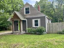 Charming bungalow with a green front door, wood porch, and landscaped yard at 1601 E 44Th St, Indianapolis, IN 46205