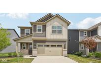 Two-story home with brown and beige siding, an attached two car garage, and covered front porch at 1911 Goodwin Pl, Westfield, IN 46074