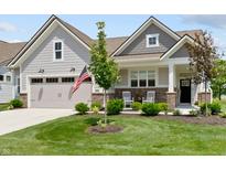 Charming home featuring a two-car garage, landscaped lawn, brick accents and cozy front porch with rocking chairs at 19959 Cowie Ln, Westfield, IN 46074