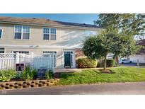 Attractive townhouse with a well-maintained lawn and a charming curb appeal at 2259 Colfax Ln # 2259, Indianapolis, IN 46260