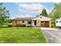 Charming brick home with well-maintained lawn, mature landscaping, and lovely curb appeal at 26858 State Road 19, Arcadia, IN 46030