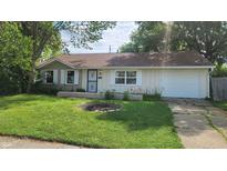 Charming single-story home with a well-maintained lawn and flowerbeds in a peaceful residential neighborhood at 2807 Carla Ct, Indianapolis, IN 46219
