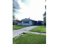 Charming ranch-style home with a well-manicured lawn and convenient covered parking at 2826 Falcon Dr, Indianapolis, IN 46222