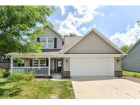 Charming two-story home with a welcoming front porch and attached two-car garage at 3067 Stilton Dr, Cicero, IN 46034