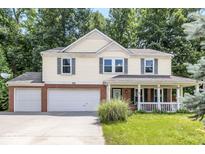 Inviting two-story home with a two car garage, classic shutters, and a charming front porch at 4223 Kestrel Ct, Indianapolis, IN 46254