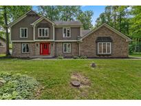 Attractive two-story home featuring a red front door, brick accents, and a well-maintained lawn at 429 Glenbrook Ln, Avon, IN 46123