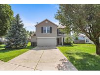 Charming two-story home with a driveway, front lawn, mature trees, and neutral-colored siding at 5519 Apple Branch Way, Indianapolis, IN 46237