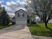 Charming two-story home with a well-maintained lawn, inviting curb appeal, and attached two car garage at 5519 Apple Branch Way, Indianapolis, IN 46237