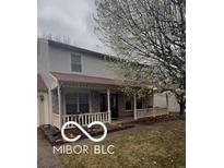 Charming two-story home with a welcoming front porch and mature flowering tree at 5826 Petersburg Pkwy, Indianapolis, IN 46254