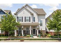 Charming two-story home with a welcoming front porch and beautifully landscaped front yard at 5832 Buskirk Dr, Indianapolis, IN 46216