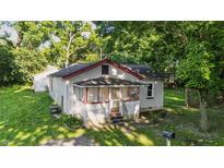 Charming home featuring a cozy screened porch and freshly mowed lawn at 637 Olin Ave, Indianapolis, IN 46222