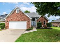 Beautiful single-story brick home with well-manicured lawn and two-car garage at 662 Leah Way, Greenwood, IN 46142