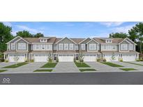 Charming two-story townhomes featuring attached garages, neutral siding, and professionally maintained landscaping at 7681 Marin Pkwy, Cumberland, IN 46229