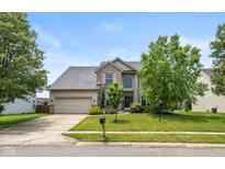 Charming two-story home with a well-manicured lawn and attached two car garage at 8336 Bent Oak Dr, Indianapolis, IN 46236