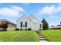 Charming one-story home with manicured lawn and inviting curb appeal under a clear blue sky at 95 S 11Th Ave, Beech Grove, IN 46107