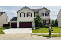 Charming two-story home with a two-car garage and a well-maintained front lawn at 9987 Rainbow Falls Ln, Fishers, IN 46037
