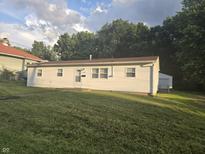 Charming single-story home with a well-maintained lawn and detached garage provides comfortable and convenient living at 1201 E Gimber St, Indianapolis, IN 46203